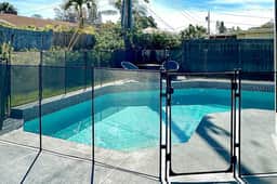 Modern coastal getaway with pool enclosed yard grill and outdoor bar