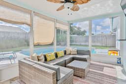 Modern coastal getaway with pool enclosed yard grill and outdoor bar