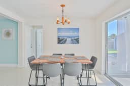 Modern coastal getaway with pool enclosed yard grill and outdoor bar
