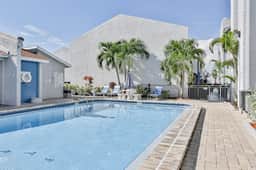 Water view condo with balcony heated pool and WD walk to beach