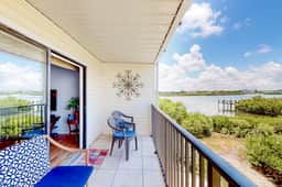 Beachfront condo with balconies grill AC and pool access steps from the sand
