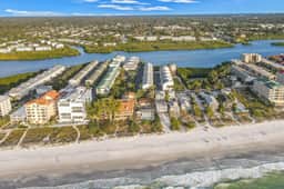 Beachfront condo with balconies grill AC and pool access steps from the sand