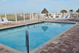 Cozy beachside condo with pool and hot tub walk to restaurants
