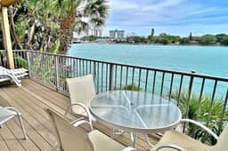 Coastal condo with multiple balconies and dock intracoastal waterway views