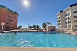 Modern cottage with peek a boo side Gulf view and beachfront heated pool and spa