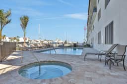 Brand new condo steps to beach with balcony heated pool and hot tub dog friendly
