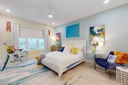 Sunlit and colorful beach condo with heated pool hot tub and balcony near shore and shops