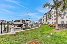 Sunlit and colorful beach condo with heated pool hot tub and balcony near shore and shops