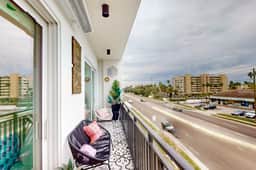 Sunlit and colorful beach condo with heated pool hot tub and balcony near shore and shops