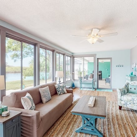 Waterfront living room with floor-to-ceiling windows in Largo