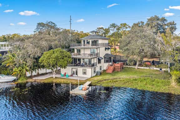 Sprawling river view estate with game room dock kayaks grill and fishing gear - Image 1