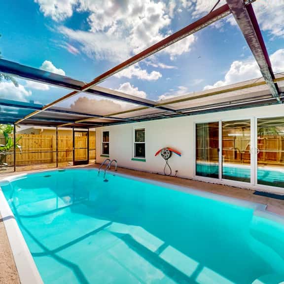 Coastal home with pool lanai patio and fireplace - Image 1