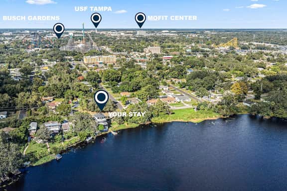 Sprawling river view estate with game room dock kayaks grill and fishing gear