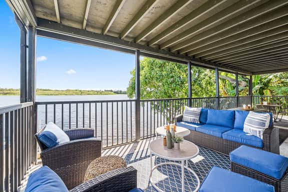 Sprawling river view estate with game room dock kayaks grill and fishing gear