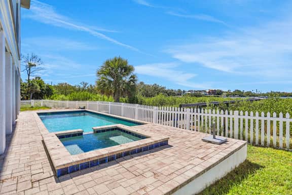 Luxurious waterfront home with pool game room dock