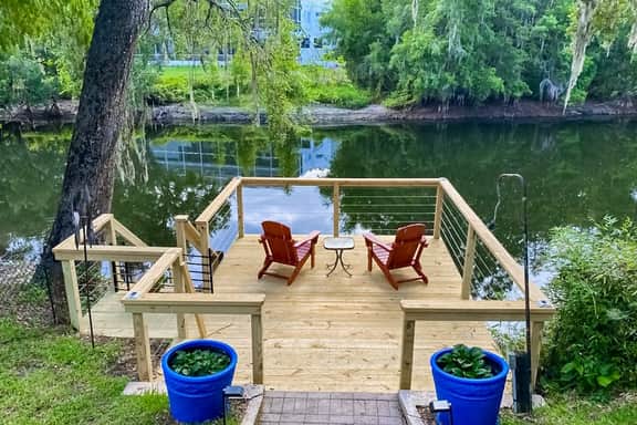 Riverfront retreat with pool spa outdoor kitchen firepit dock sauna and games