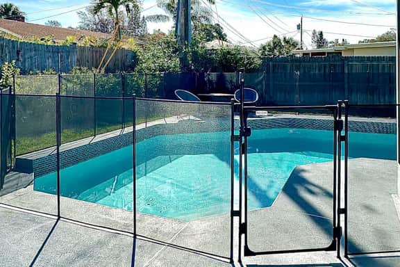 Modern coastal getaway with pool enclosed yard grill and outdoor bar
