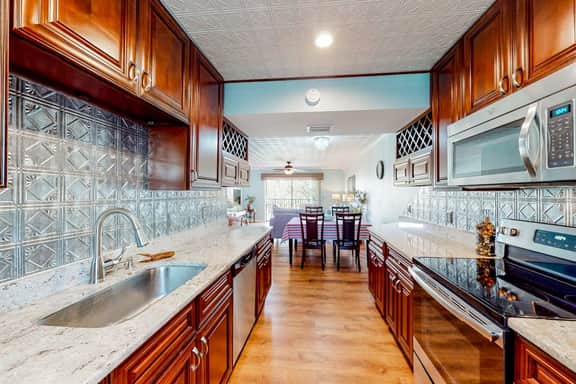 Beachfront condo with balconies grill AC and pool access steps from the sand