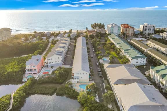 Beachfront condo with balconies grill AC and pool access steps from the sand