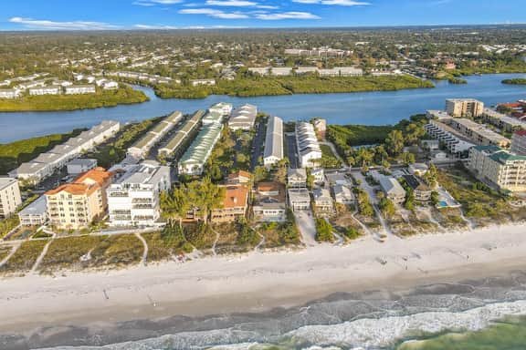 Beachfront condo with balconies grill AC and pool access steps from the sand