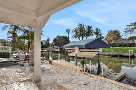 Snowbird friendly elegant home with waterfront location pool grill fireplace