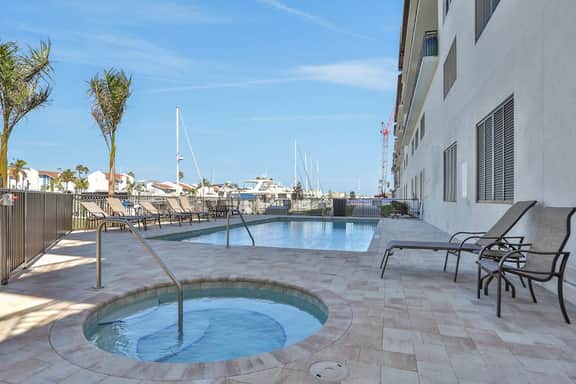 Brand new condo steps to beach with balcony heated pool and hot tub dog friendly