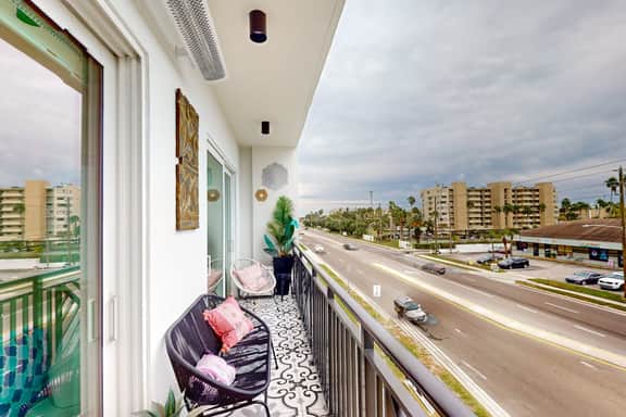 Sunlit and colorful beach condo with heated pool hot tub and balcony near shore and shops