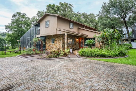 Riverfront retreat with pool spa outdoor kitchen firepit dock sauna and games
