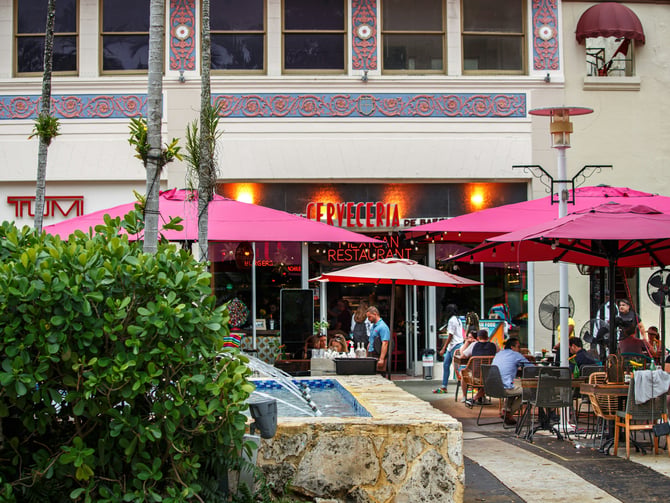Outdoor dining with palms and warm evening light