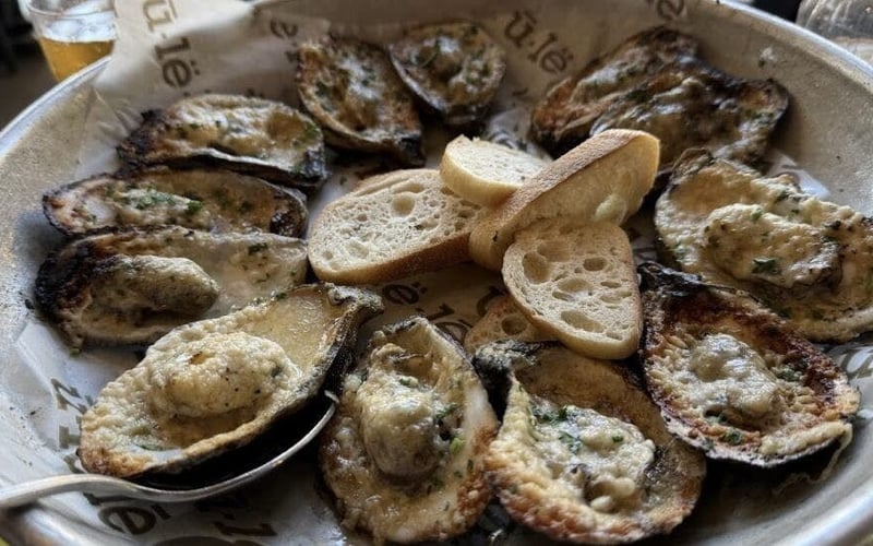 Wood-roasted oysters with herb butter and grilled bread at Ulele