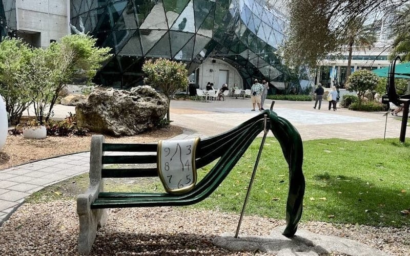 Melting clock bench sculpture in the Avant-garden