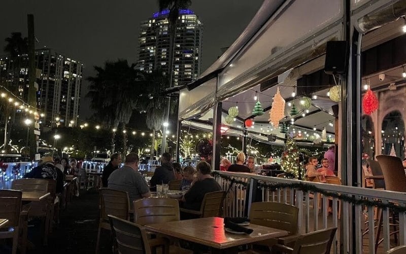 Fresco's Waterfront Bistro outdoor patio lit up at night with city skyline views