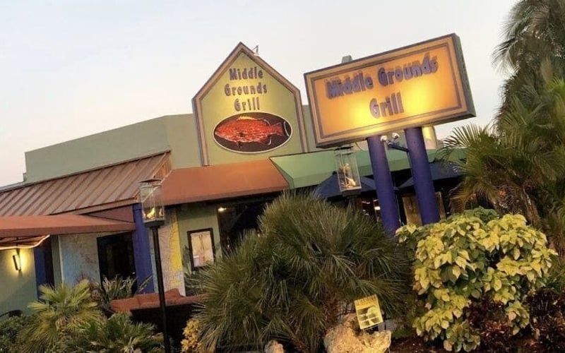 Middle Grounds Grill exterior at dusk with illuminated signage