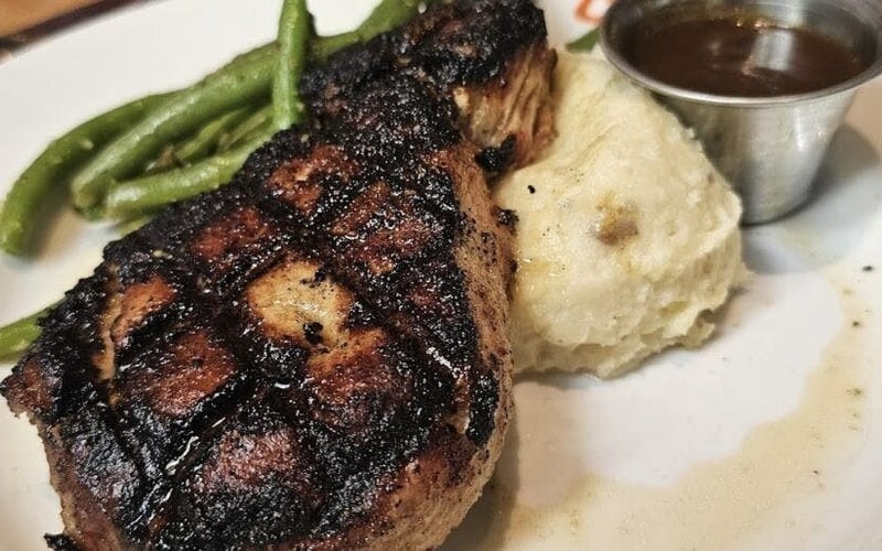 Wood-grilled ribeye with mashed potatoes and green beans at Ulele