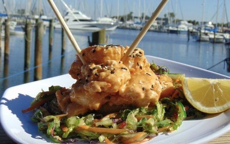 Crispy shrimp skewers with sesame and slaw at the marina