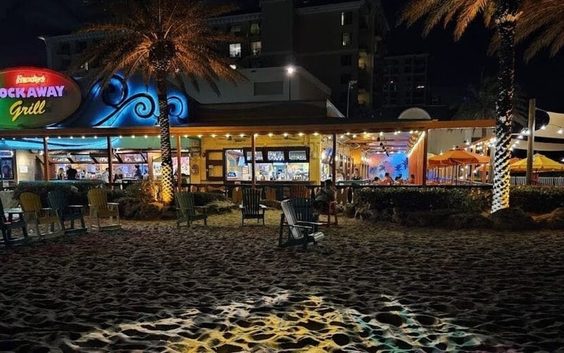 Frenchy's Rockaway Grill exterior lit up at night on the beach