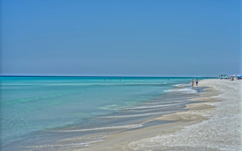 Quiet white sand beach with clear turquoise Gulf water
