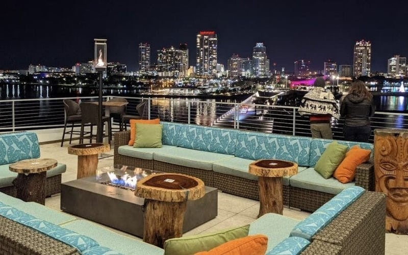 Rooftop bar at St. Pete Pier with city skyline at night