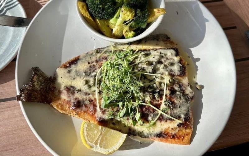 Pan-seared whole fish with capers, microgreens and broccoli at Fresco's