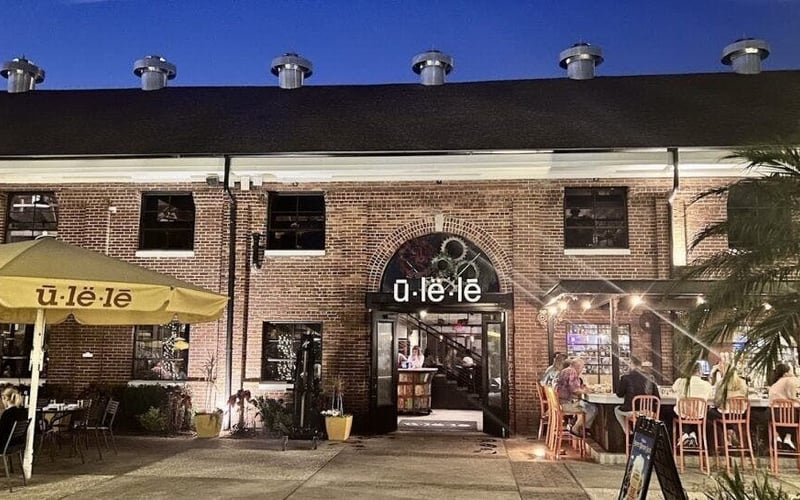 Ulele restaurant brick exterior with outdoor patio seating at night