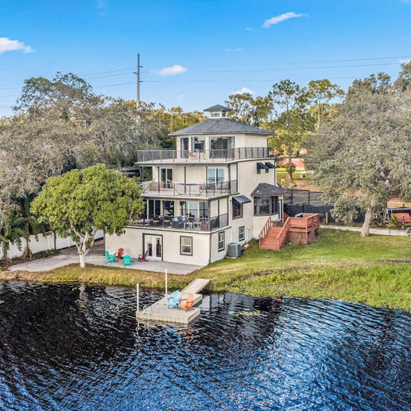 Sprawling river view estate with game room dock kayaks grill and fishing gear